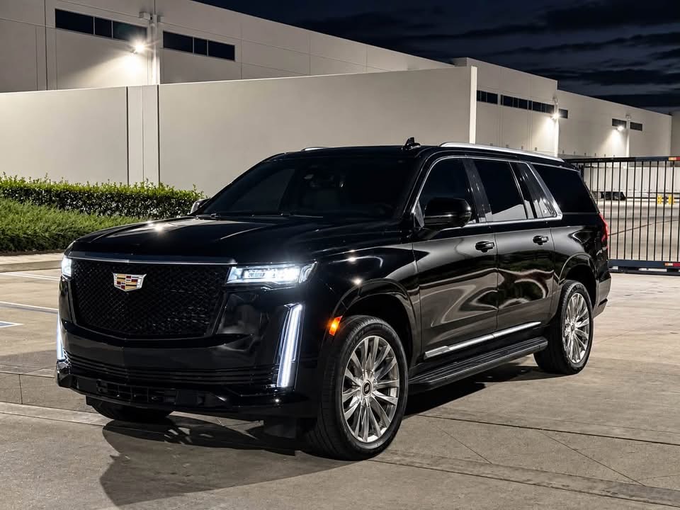 Black Cadillac at night, opposite front angle